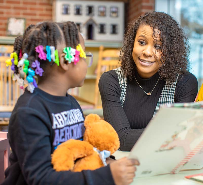 woman in library with child