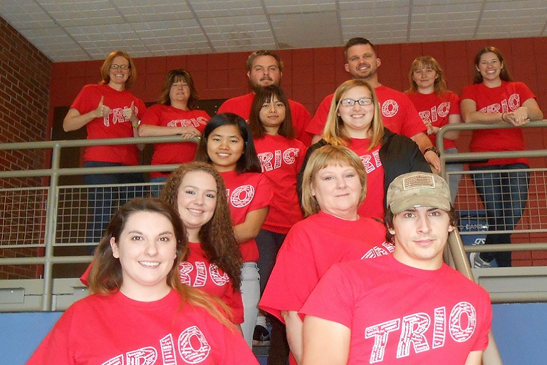 Group of students standing on stairs wearing TRIO t-shirts. 