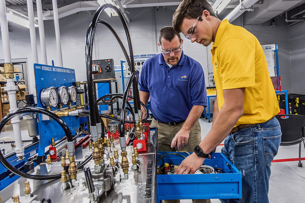 student and instructor working on panels