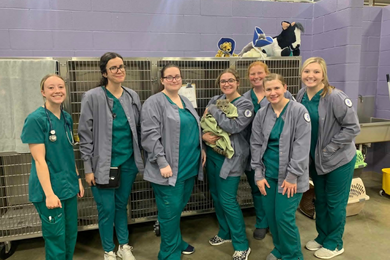 group of vet tech students with cat